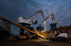 Mantsinen 120R und Fuchs MHL340F im gemeinsamen Einsatz beim Umschlag von Holzhackschnitzel.