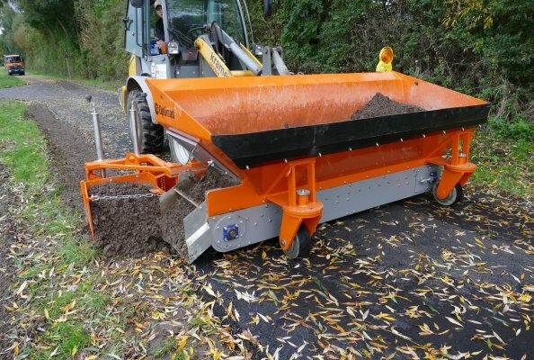 Die Optimas Finliner Materialverteilschaufel in der 1,4 m³ Variante bei der Bankettreparatur.