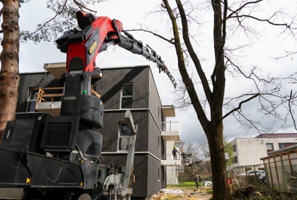 Balkongeländerteile müssen sicher über das Mehrparteienhaus gehoben werden – eine Aufgabe, die der PK 580 TEC souverän meistert. 